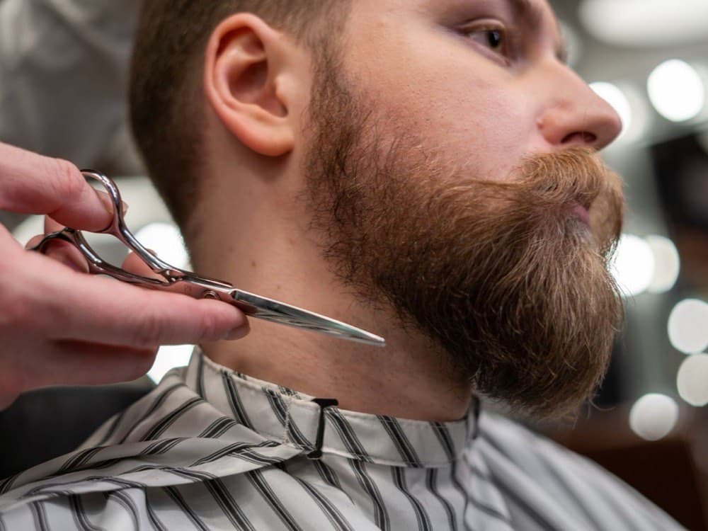 Close-up of a beard outline being groomed