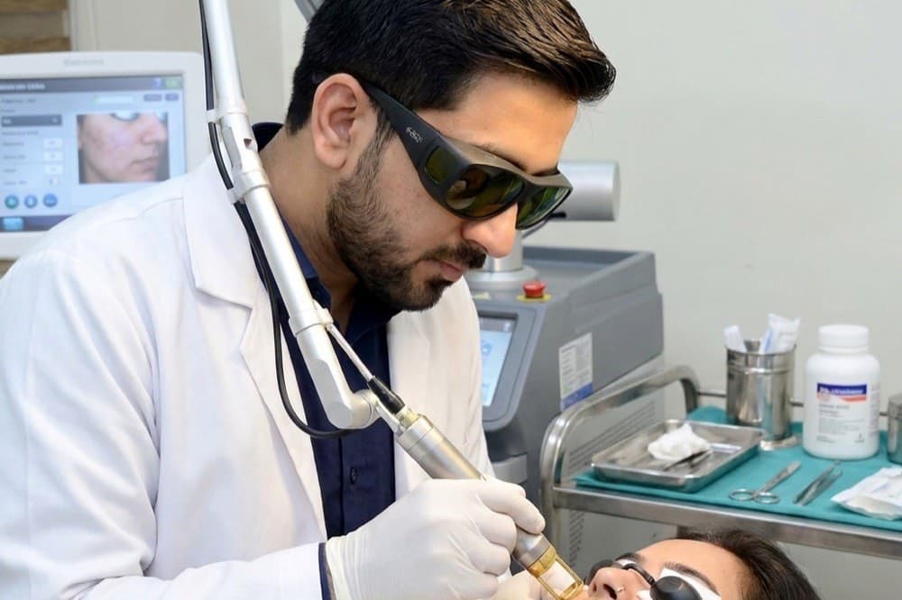 A laser handpiece being used during a skin treatment