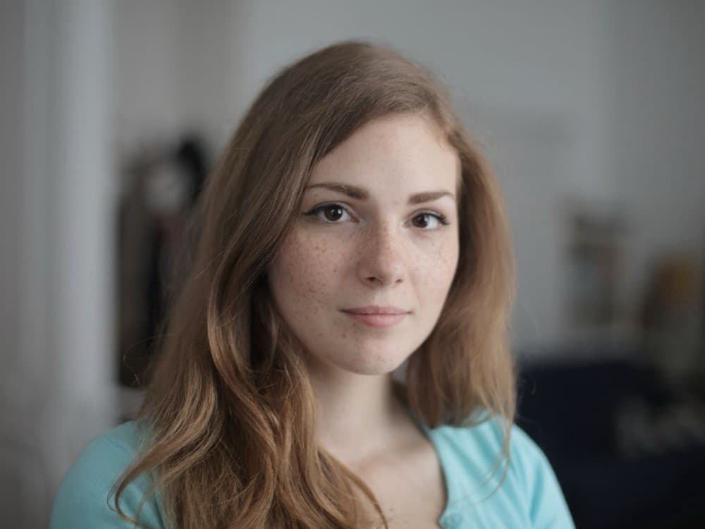 Portrait showing freckles across the cheeks and nose