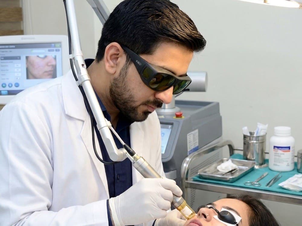 Dr. Raghvendra Pratap Singh performing a Q-Switched laser procedure on a patient at MySkin Clinic, Orai