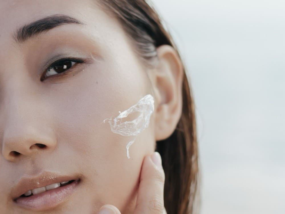 Close-up of a person applying skincare to the face